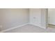 Unfurnished bedroom with double closet doors and neutral-colored carpet at 7814 Nc 27, Coats, NC 27521