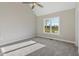 Sunlit bedroom with plush carpet and a large window at 7814 Nc 27, Coats, NC 27521