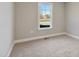 Empty bedroom with neutral carpet and a single window at 7814 Nc 27, Coats, NC 27521