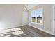 Dining area with wood-look floors, chandelier, and windows overlooking the backyard at 7814 Nc 27, Coats, NC 27521
