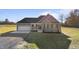 Inviting green two-story home on a sunny day with a two-car garage and spacious front lawn at 7814 Nc 27, Coats, NC 27521