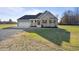 A single-story home with a two-car garage, a covered porch, and a green lawn at 7814 Nc 27, Coats, NC 27521