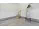 Garage interior with wooden staircase to attic and water heater at 7814 Nc 27, Coats, NC 27521