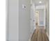 Hallway with wood-look flooring and white doors at 7814 Nc 27, Coats, NC 27521