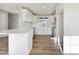 White kitchen featuring stainless steel appliances, white countertops, and wood-look floors at 7814 Nc 27, Coats, NC 27521