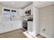 Kitchen with white cabinets, stainless steel appliances, white countertops, and wood-look floors at 7814 Nc 27, Coats, NC 27521