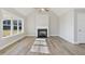 Living room featuring a fireplace, wood-look floors, and ample natural light at 7814 Nc 27, Coats, NC 27521