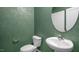 Powder room with green textured walls and a round mirror at 758 Dorset Stream Dr, Fuquay Varina, NC 27526