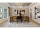 Elegant dining room with a wooden table, chandelier, and abstract art at 116 E Star Foal Ln, Wendell, NC 27591