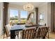Bright dining room with large windows overlooking backyard and a farmhouse style table at 116 E Star Foal Ln, Wendell, NC 27591