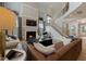 Living room with a fireplace, high ceilings, and a view of the staircase at 116 E Star Foal Ln, Wendell, NC 27591