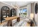 Home office with large windows, wooden desk, and stylish light fixture at 116 E Star Foal Ln, Wendell, NC 27591