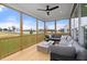 Relaxing screened porch with sectional sofa and wooden deck at 116 E Star Foal Ln, Wendell, NC 27591