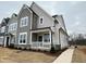 Modern two-story home with gray and white siding, white trim, and covered front porch at 3185 Mission Olive Pl # 348, New Hill, NC 27562