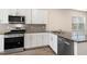Modern kitchen with stainless steel appliances and granite countertops at 804 Dorset Stream Dr, Fuquay Varina, NC 27526