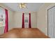 Bright bedroom with hardwood floors and red curtains at 813 Tucker St, Burlington, NC 27215