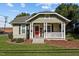 Charming bungalow with a covered front porch and landscaped yard at 813 Tucker St, Burlington, NC 27215