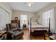 Bedroom with hardwood floors, a double bed, and a recliner at 813 Tucker St, Burlington, NC 27215