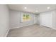 Bright and airy living room featuring light gray walls and wood-look flooring at 1112 Kitt Pl, Raleigh, NC 27610