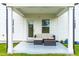 Covered patio with seating area adjacent to the house at 137 Tayberry Ct, Holly Springs, NC 27540