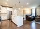 White kitchen with island, stainless steel appliances, and open view to living area at 10530 Sablewood Dr # 105, Raleigh, NC 27617