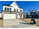 Charming two-story home with a white and stone facade, two-car garage, and inviting front yard at 125 S Stone Mill Trl # 241, Clayton, NC 27520