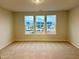 Spacious bedroom with carpeting and large windows with neighborhood view at 29 Nettle Ln # 235, Clayton, NC 27520