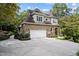 Stone and shingle two-story home with a two-car garage and manicured landscaping at 32430 Archdale, Chapel Hill, NC 27517