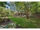 Landscaped backyard with lush greenery and stone wall at 32430 Archdale, Chapel Hill, NC 27517