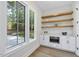 Built-in coffee bar with white cabinets and floating shelves at 7800 Ailesbury Rd, Wake Forest, NC 27587