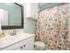 Clean bathroom with floral shower curtain and white vanity at 175 Jacqueline Dr, Willow Springs, NC 27592