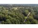 Aerial view of a wooded lot with a paved road at 118 W Silver Belle Dr, Zebulon, NC 27597