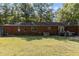 Rear view of brick home with deck and large backyard at 118 W Silver Belle Dr, Zebulon, NC 27597