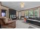 Spacious living room featuring a large TV, comfortable seating, and ample natural light at 118 W Silver Belle Dr, Zebulon, NC 27597