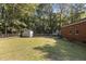 Backyard with storage shed, chain link fence, and a partially visible car at 118 W Silver Belle Dr, Zebulon, NC 27597