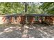 Brick ranch house with a wooden front porch and a gravel driveway at 118 W Silver Belle Dr, Zebulon, NC 27597