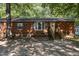 Brick ranch house with a wooden front porch and a gravel driveway at 118 W Silver Belle Dr, Zebulon, NC 27597