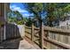 Small fenced backyard with a wooden fence and gate at 5620 Bridgetowne Way, Raleigh, NC 27609