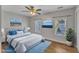 Main bedroom with plush bed and two windows at 5620 Bridgetowne Way, Raleigh, NC 27609