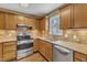 Modern kitchen featuring stainless steel appliances and granite countertops at 5620 Bridgetowne Way, Raleigh, NC 27609