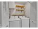 Convenient laundry room with washer, dryer, and shelving at 5620 Bridgetowne Way, Raleigh, NC 27609