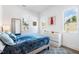 Bedroom with blue bedding, dresser, and artwork on the wall at 1511 Malta Ave, Raleigh, NC 27610