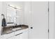 Bathroom vanity with gray countertop, black fixtures, and modern design at 1511 Malta Ave, Raleigh, NC 27610