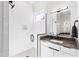 Modern bathroom with a white tile shower and gray countertop at 1511 Malta Ave, Raleigh, NC 27610