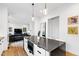 Open concept kitchen features a large island, hardwood floors, and modern lighting at 1511 Malta Ave, Raleigh, NC 27610