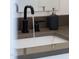 Close-up of modern bathroom sink with black faucet and matte gray soap dispenser at 1511 Malta Ave, Raleigh, NC 27610