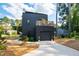 Modern black home with a rooftop deck and attached garage at 1511 Malta Ave, Raleigh, NC 27610