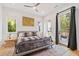 Spacious bedroom with a king-size bed, access to a deck, and large windows at 1511 Malta Ave, Raleigh, NC 27610