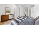 Bright bedroom with mid-century dresser and soft gray blanket at 1511 Malta Ave, Raleigh, NC 27610