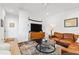 Spacious living area with leather sofa, coffee table, and wood floors at 1511 Malta Ave, Raleigh, NC 27610